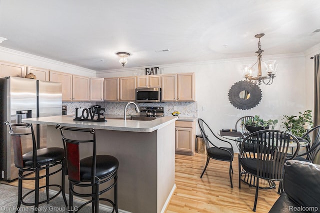 3994 Forester Blvd, Auburn Hills, MI 48326 - kitchen featuring appliances with stainless steel finishes, light brown cabinetry, a kitchen bar, light wood finished floors, and decorative backsplash