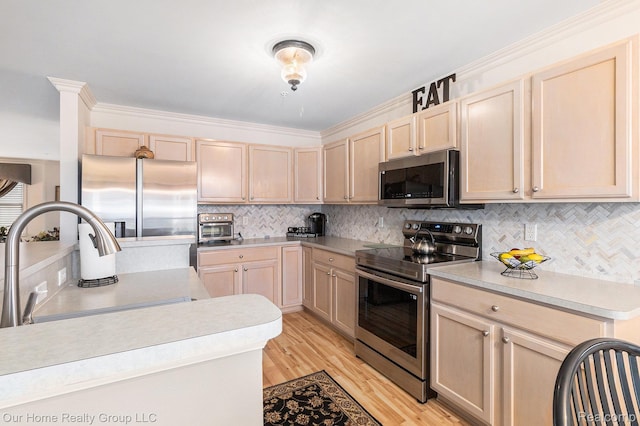 3994 Forester Blvd, Auburn Hills, MI 48326 - kitchen with appliances with stainless steel finishes, light brown cabinets, light countertops, decorative backsplash, and light wood-style flooring