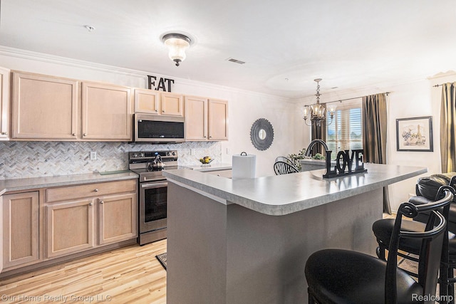 3994 Forester Blvd, Auburn Hills, MI 48326 - kitchen with stainless steel appliances, a breakfast bar, light brown cabinetry, decorative backsplash, and ornamental molding