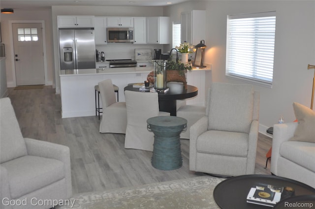 1530 Parmenter Ct Unit 18, Petoskey, MI 49770 - living room with light wood-style floors and healthy amount of natural light