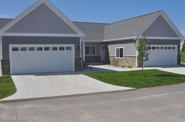 1530 Parmenter Ct Unit 18, Petoskey, MI 49770 - craftsman-style home with stone siding, an attached garage, roof with shingles, and driveway