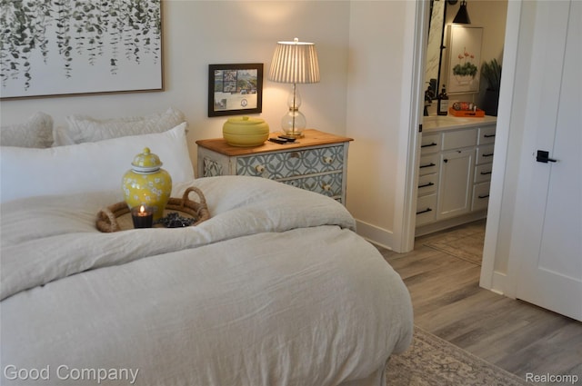 1530 Parmenter Ct Unit 18, Petoskey, MI 49770 - bedroom with wood finished floors and ensuite bath