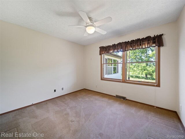 3225 W Marr Rd, Howell, MI 48855 - carpeted spare room with a textured ceiling and ceiling fan