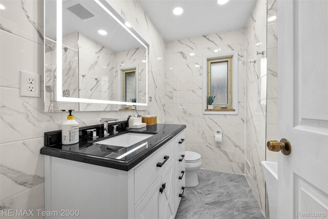 30695 Lyndon St, Livonia, MI 48154 - full bath featuring vanity, tile walls, marble finish floors, and recessed lighting