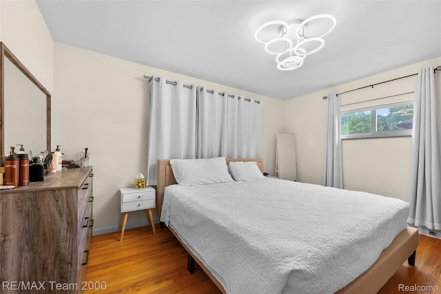 30695 Lyndon St, Livonia, MI 48154 - bedroom with light wood-type flooring and a chandelier