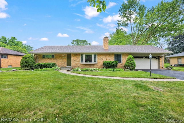 30695 Lyndon St, Livonia, MI 48154 - ranch-style home featuring a garage, a chimney, a front lawn, and asphalt driveway