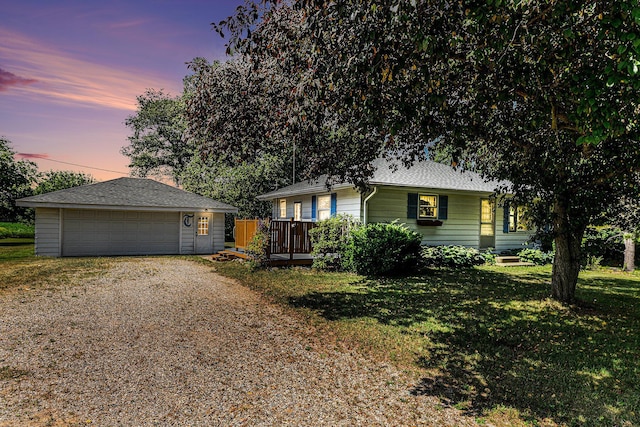 356 Riverview Dr, Plainwell, MI 49080 - view of front of house with an outbuilding, a detached garage, a front yard, driveway, and roof with shingles