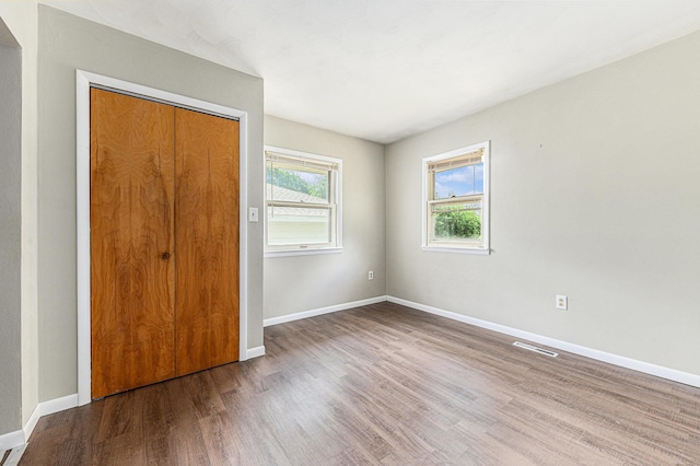 356 Riverview Dr, Plainwell, MI 49080 - unfurnished bedroom with wood finished floors and a closet