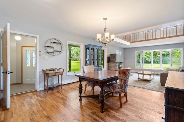 9719 King Rd, Spring Arbor, MI 49283 - dining room featuring a chandelier, light wood-style floors, and healthy amount of natural light