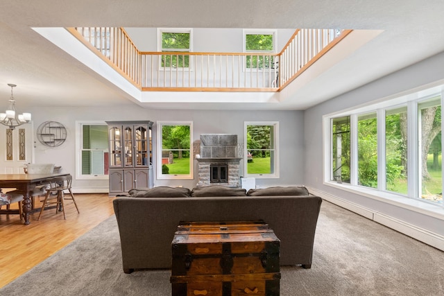 9719 King Rd, Spring Arbor, MI 49283 - living area with a high ceiling, a chandelier, a fireplace, and wood finished floors