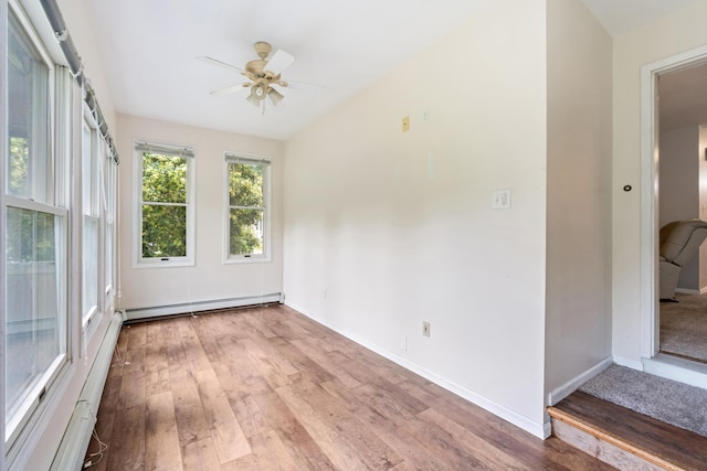 9719 King Rd, Spring Arbor, MI 49283 - unfurnished room featuring a baseboard radiator, ceiling fan, light wood finished floors, and vaulted ceiling