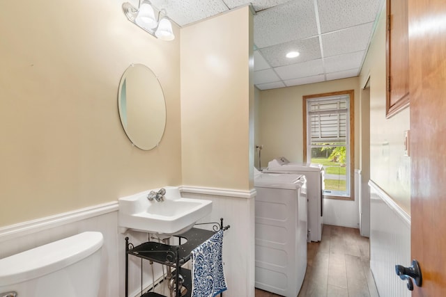 9719 King Rd, Spring Arbor, MI 49283 - half bath featuring washer and dryer, a wainscoted wall, a paneled ceiling, and wood finished floors