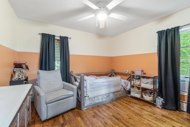 9719 King Rd, Spring Arbor, MI 49283 - bedroom with wood finished floors, ceiling fan, and a baseboard heating unit