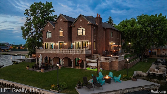 328 S Broadway St, Lake Orion, MI 48362 - back of house featuring a fire pit, a patio, a lawn, and a deck