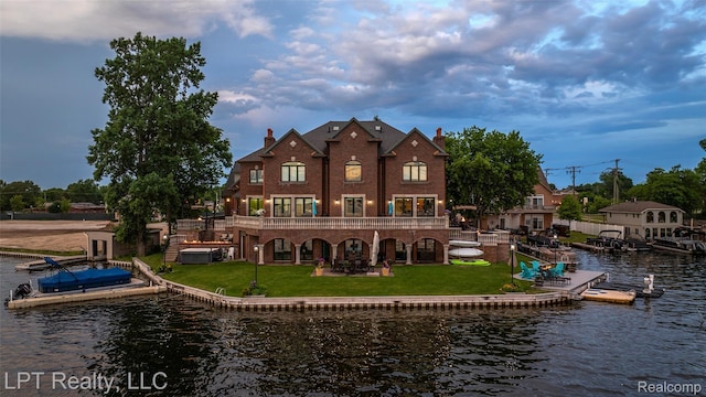 328 S Broadway St, Lake Orion, MI 48362 - rear view of property with a water view, a lawn, a chimney, and a patio area