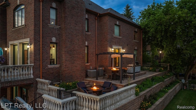 328 S Broadway St, Lake Orion, MI 48362 - rear view of house with an outdoor fire pit, brick siding, a patio area, and a pergola