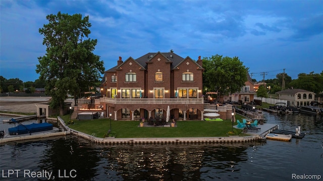 328 S Broadway St, Lake Orion, MI 48362 - back of property with a water view, a lawn, a patio, and a chimney
