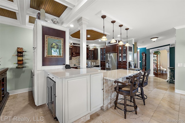328 S Broadway St, Lake Orion, MI 48362 - kitchen with stainless steel refrigerator with ice dispenser, ornamental molding, a peninsula, ornate columns, and light countertops