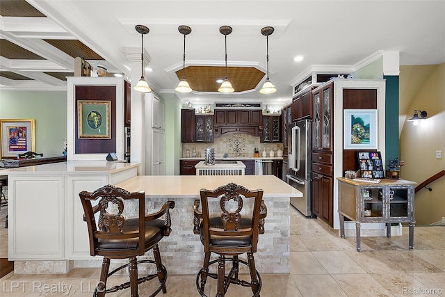 328 S Broadway St, Lake Orion, MI 48362 - kitchen with appliances with stainless steel finishes, light countertops, a peninsula, crown molding, and dark brown cabinets