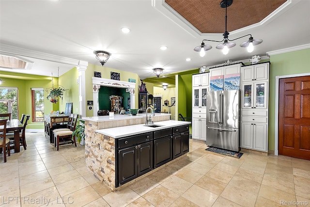 328 S Broadway St, Lake Orion, MI 48362 - kitchen with high quality fridge, crown molding, light countertops, a kitchen island with sink, and decorative light fixtures