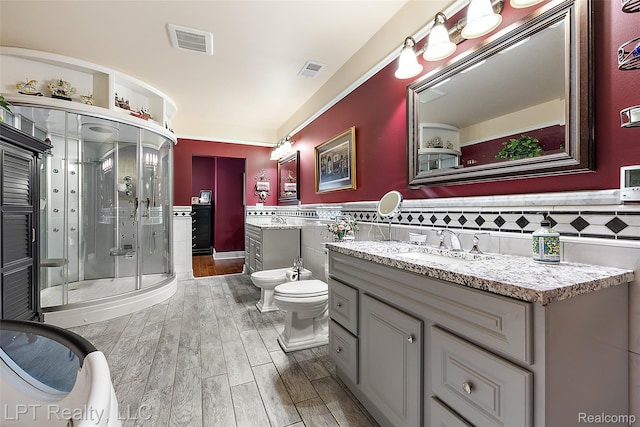 328 S Broadway St, Lake Orion, MI 48362 - bathroom with a bidet, tile walls, vanity, a stall shower, and wood finished floors