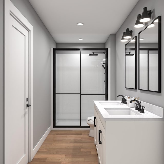 2862 Jade Ln, Traverse City, MI 49684 - full bathroom with a shower stall, vanity, wood finished floors, and recessed lighting