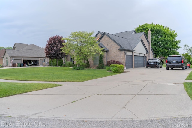 14607 Stratford, Shelby Twp, MI 48315 - view of front facade with a front lawn, an attached garage, brick siding, a chimney, and driveway