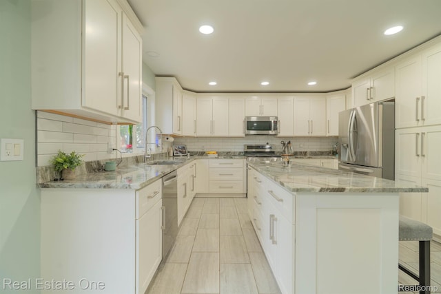 14607 Stratford, Shelby Twp, MI 48315 - kitchen with appliances with stainless steel finishes, backsplash, white cabinetry, and recessed lighting