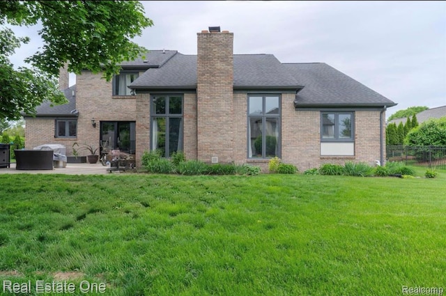 14607 Stratford, Shelby Twp, MI 48315 - rear view of property featuring a chimney, brick siding, a patio area, and roof with shingles