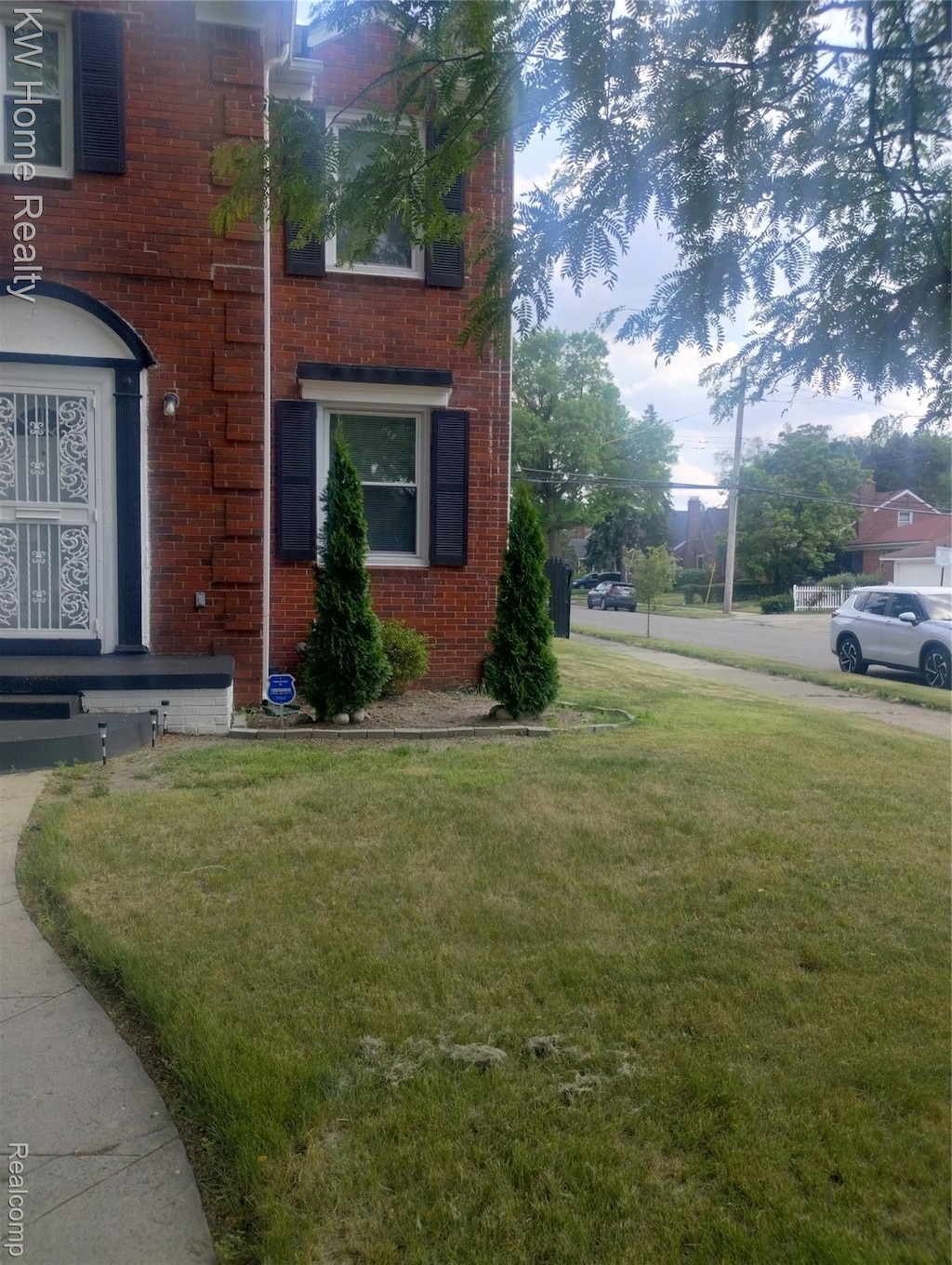 13645 Vassar Ave, Detroit, MI 48235 - view of home's exterior with brick siding and a lawn
