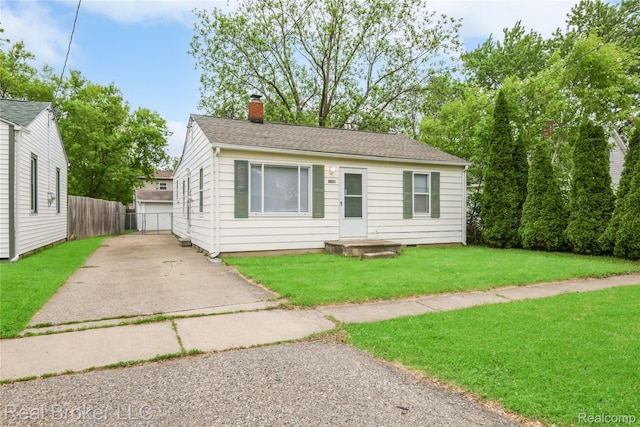 1165 Carman St, Burton, MI 48529 - view of front of home with a chimney and roof with shingles