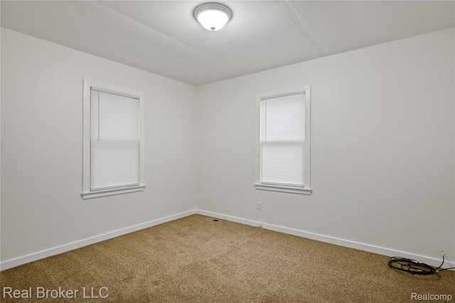 1165 Carman St, Burton, MI 48529 - carpeted spare room with baseboards