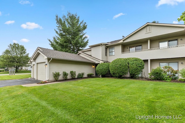 2685 Hillandale Dr NW, Walker, MI 49534 - view of front facade with a front yard, a garage, and driveway