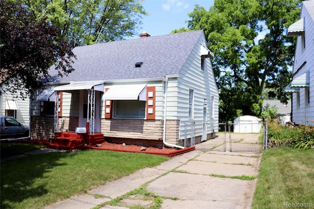 329 Bede St, Otisville, MI 48507 - view of front facade with roof with shingles, a gate, a chimney, stone siding, and driveway