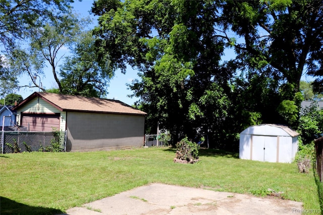 329 Bede St, Otisville, MI 48507 - view of yard featuring a storage unit, a garage, and a patio area