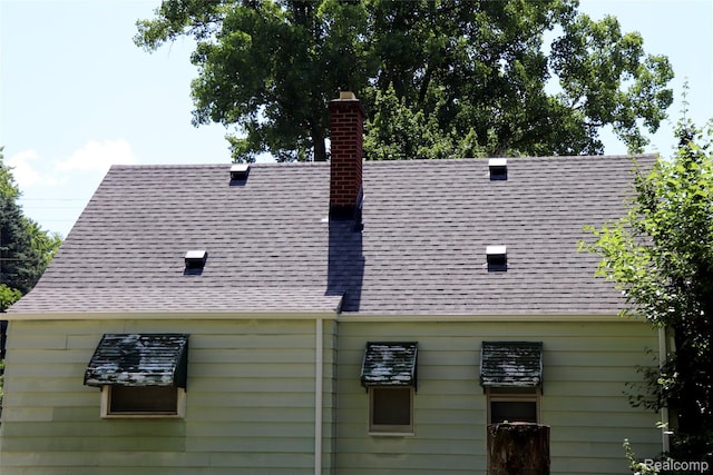 329 Bede St, Otisville, MI 48507 - exterior view of a chimney and a shingled roof