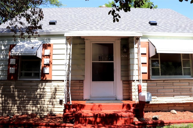 329 Bede St, Otisville, MI 48507 - view of exterior entry featuring roof with shingles
