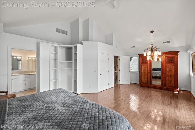 6847 Alden Dr, West Bloomfield, MI 48324 - bedroom with high vaulted ceiling, a chandelier, light wood-style floors, and ensuite bath