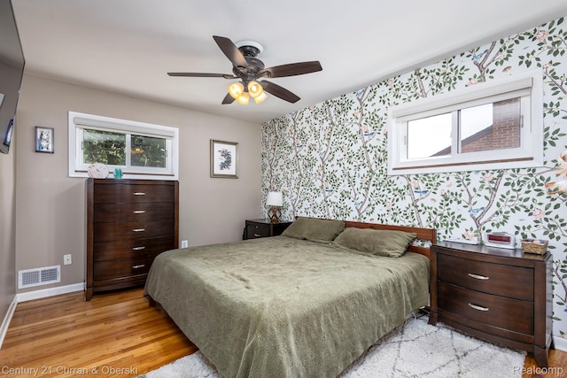 32204 Leelane, Farmington, MI 48336 - bedroom with wallpapered walls, light wood-style flooring, multiple windows, and a ceiling fan