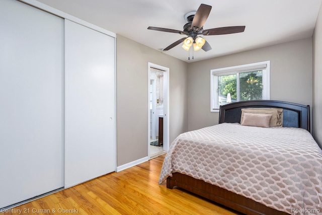 32204 Leelane, Farmington, MI 48336 - bedroom featuring wood finished floors, a closet, ensuite bath, and ceiling fan