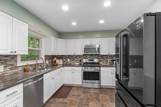 437 Collindale Ave NW, Grand Rapids, MI 49504 - kitchen with stainless steel appliances, white cabinets, backsplash, and recessed lighting
