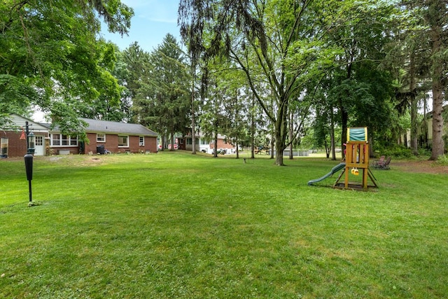 437 Collindale Ave NW, Grand Rapids, MI 49504 - view of grassy yard featuring a playground