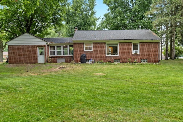 437 Collindale Ave NW, Grand Rapids, MI 49504 - back of house featuring brick siding, a yard, a chimney, and roof with shingles