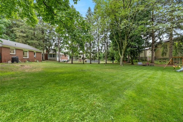 437 Collindale Ave NW, Grand Rapids, MI 49504 - view of green lawn featuring a playground