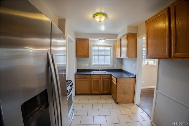 22613 Raven Ave, Eastpointe, MI 48021 - kitchen featuring stainless steel fridge with ice dispenser, brown cabinets, plenty of natural light, and range