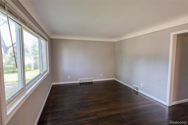 22613 Raven Ave, Eastpointe, MI 48021 - empty room with dark wood finished floors and baseboards