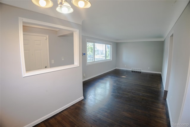 22613 Raven Ave, Eastpointe, MI 48021 - empty room with dark wood-type flooring and a chandelier