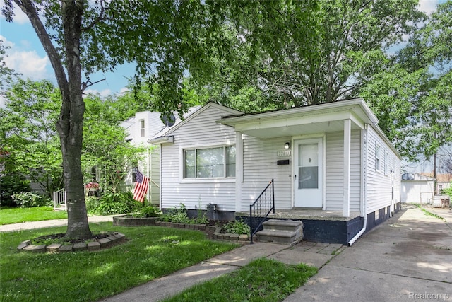 22613 Raven Ave, Eastpointe, MI 48021 - view of front of house featuring a front yard and an outbuilding