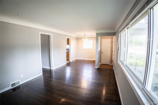 22613 Raven Ave, Eastpointe, MI 48021 - spare room with a chandelier, healthy amount of natural light, and dark wood-type flooring