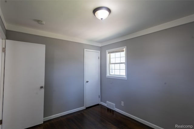 22613 Raven Ave, Eastpointe, MI 48021 - unfurnished bedroom with dark wood-type flooring and a closet